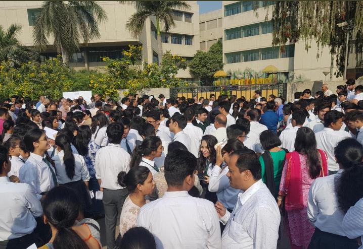 students holding admit cards outside exam center | Photo Credit : attachowk.com